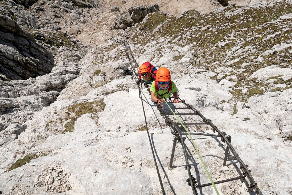 guided ascent on secured climbing route jof di montasio - montaz