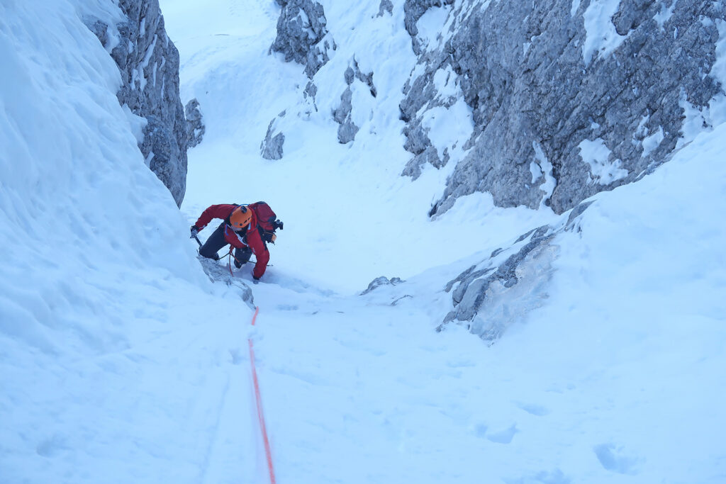 Slovenian route ascent in Triglav north wall in winter conditions