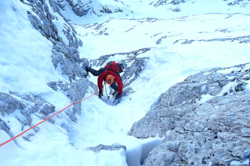 Slovenian route guided climb in Triglav north wall in winter time